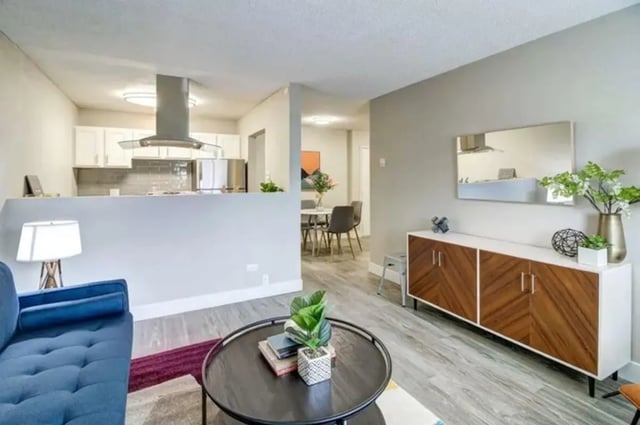 Blue sofa dining area kitchen open living room at Copper Chase Apartments in Colorado Springs Student Accommodation