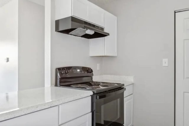 Black stove white cabinets modern kitchen at Lincoln Springs Apartments in Colorado Springs Student Accommodation