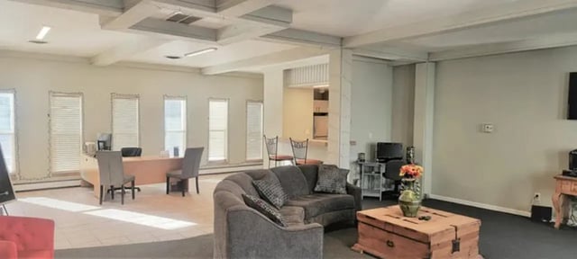 Sofa chest coffee table desk and chairs living area at Lincoln Springs Apartments in Colorado Springs Student Accommodation