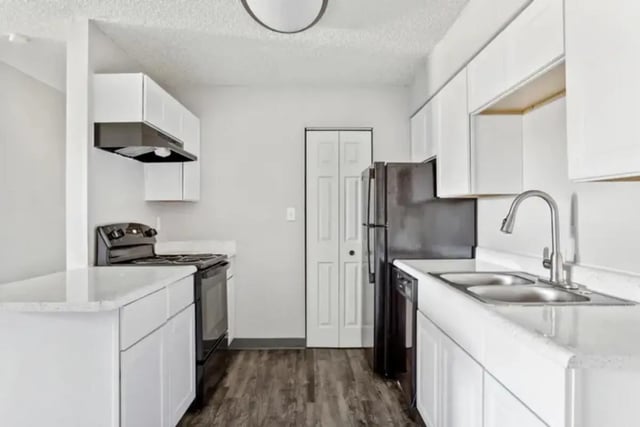 Stove refrigerator sink cabinets white kitchen at Lincoln Springs Apartments in Colorado Springs Student Accommodation