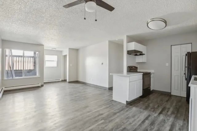 Empty apartment with kitchen and living area at Lincoln Springs Apartments in Colorado Springs Student Accommodation