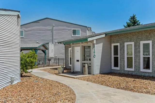 Walkway with buildings and trees exterior at Lincoln Springs Apartments in Colorado Springs Student Accommodation
