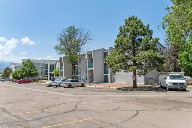 Apartment buildings cars and van exterior at Lincoln Springs Apartments in Colorado Springs Student Accommodation