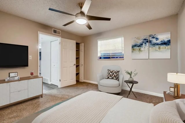 Bed dresser TV and chair bedroom at Newgate in Wheat Ridge Student Accommodation