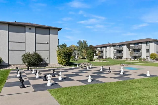 Giant chess set on pavement grass buildings exterior at Newgate in Wheat Ridge Student Accommodation