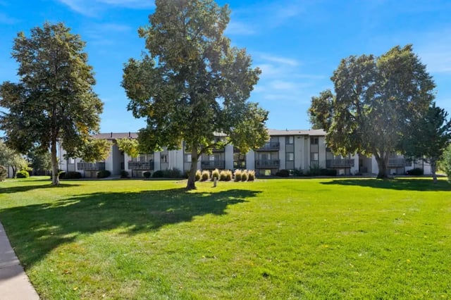 Apartment building with balconies and lawn exterior at Newgate in Wheat Ridge Student Accommodation