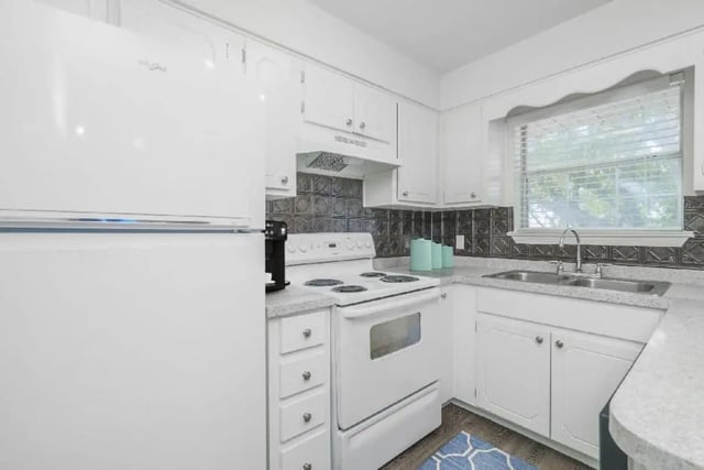 White refrigerator stove sink and cabinets kitchen at Newport Square Apartments in Colorado Springs Student Accommodation