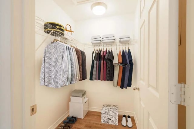 Closet with hanging clothes shoes boxes closet at Newport Square Apartments in Colorado Springs Student Accommodation