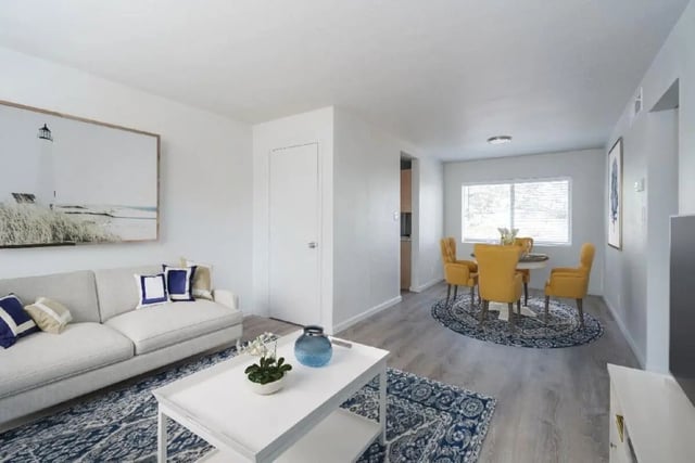 Sofa coffee table dining set lighthouse painting living room at Newport Square Apartments in Colorado Springs Student Accommodation