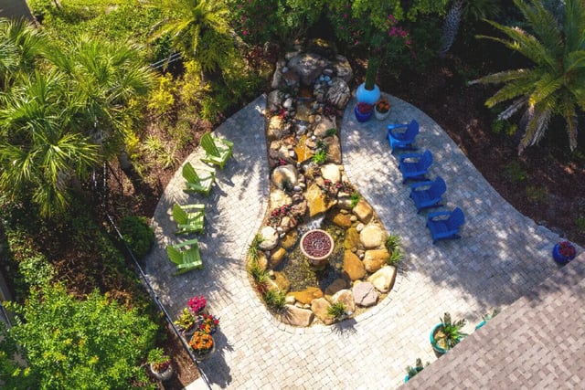 Lush garden with chairs and waterfall outdoor area at Newport Square Apartments in Colorado Springs Student Accommodation