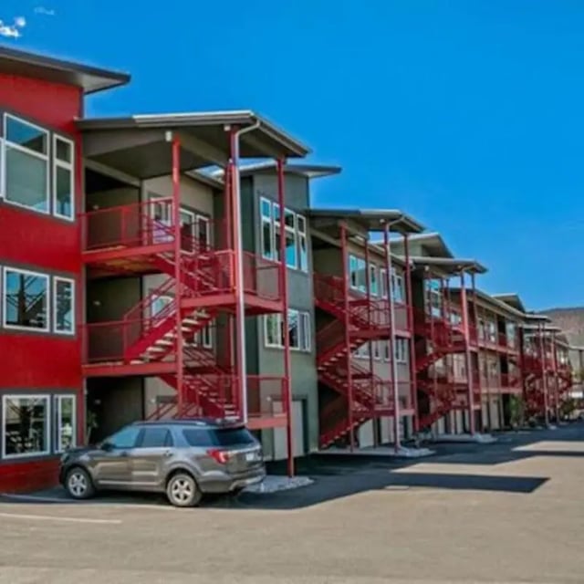 Modern apartment building with red exterior stairs exterior at Red Table Apartments in Gypsum Student Accommodation