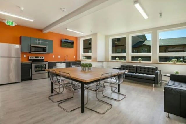 Kitchen with dining table and seating living area kitchen exterior at Red Table Apartments in Gypsum Student Accommodation