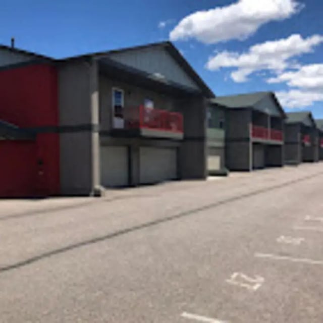 Apartment buildings with red balconies and garages exterior at Red Table Apartments in Gypsum Student Accommodation