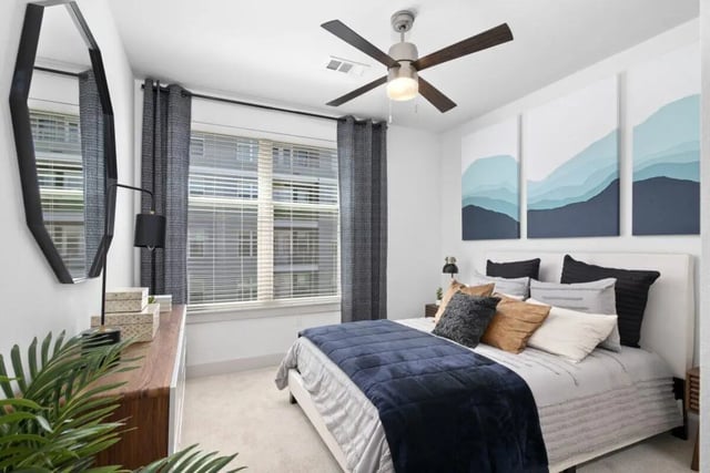 Bed with navy blanket artworks abstract landscape Bedroom at RYE SoBo in Denver Student Accommodation