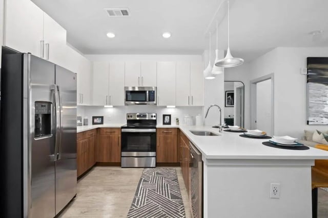 Modern kitchen with stainless steel appliances and island kitchen at RYE SoBo in Denver Student Accommodation