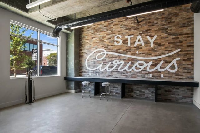Brick wall art bike station bar stools common area at RYE SoBo in Denver Student Accommodation