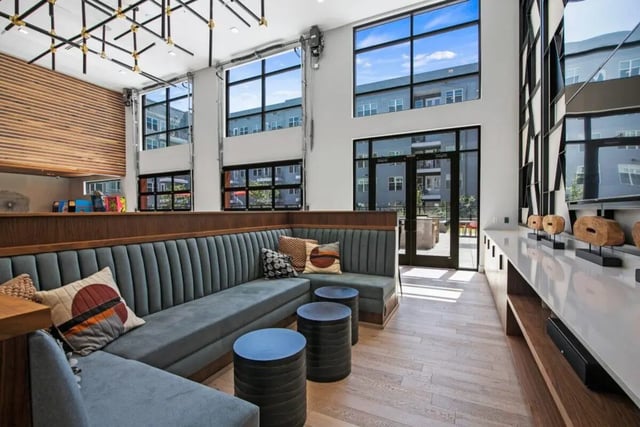 Modern sectional sofa with colorful pillows and tables lounge at RYE SoBo in Denver Student Accommodation