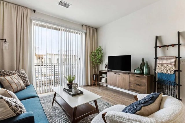 Blue couch coffee table tv stand living room at Vida @ Fitzsimons in Aurora Student Accommodation