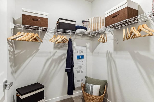 Closet with hangers storage boxes robe laundry basket closet at Vida @ Fitzsimons in Aurora Student Accommodation