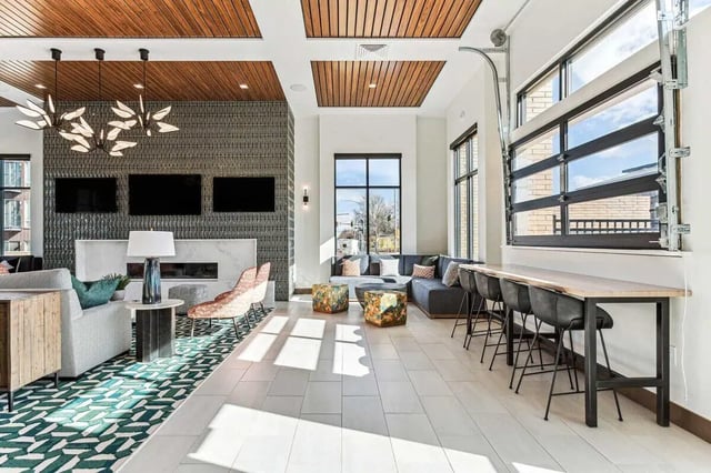 Modern lounge with sectional sofa bar stools living room at Vida @ Fitzsimons in Aurora Student Accommodation