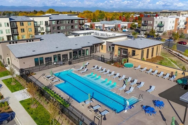 Pool with lounge chairs and tables exterior at Vida @ Fitzsimons in Aurora Student Accommodation