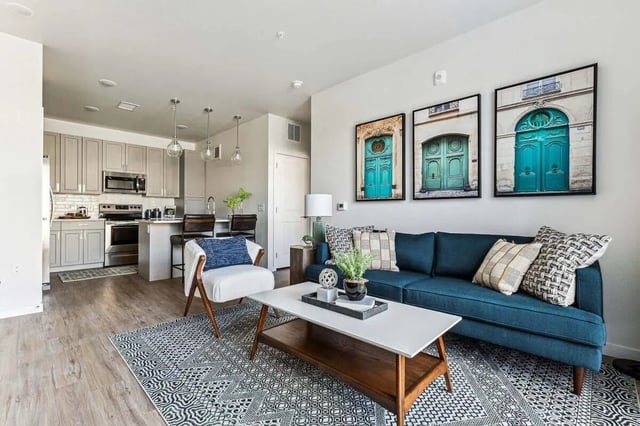 Sofa kitchen artwork and chair living room at Vida @ Fitzsimons in Aurora Student Accommodation