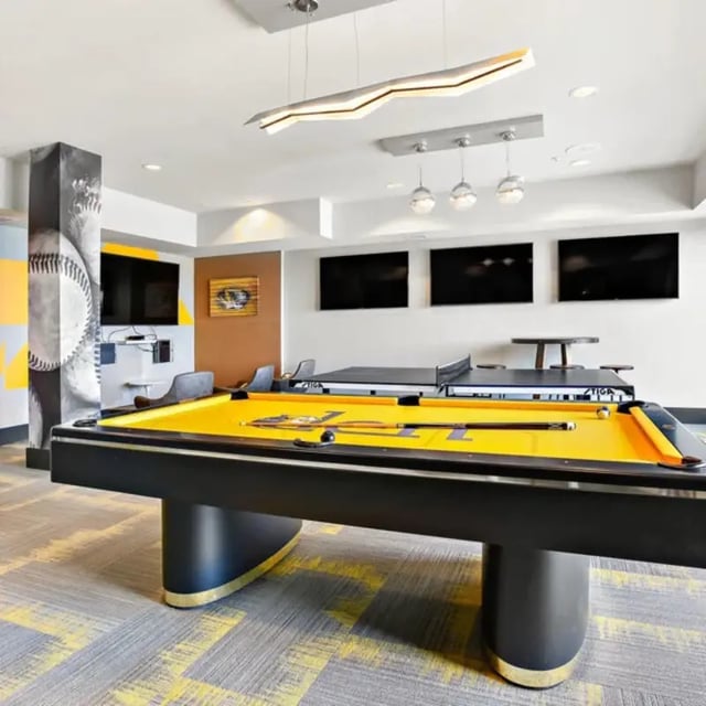Pool table ping pong table and TVs recreation room at The Den in Columbia Student Accommodation