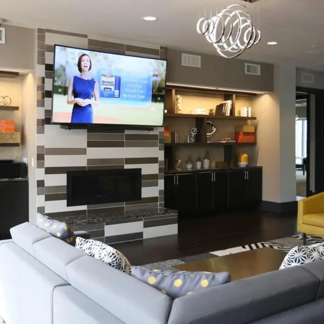 Gray sectional sofa with patterned pillows living room at The Den in Columbia Student Accommodation