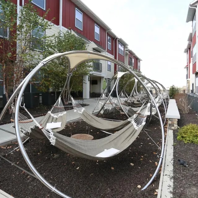 Hammocks under arches exterior at The Den in Columbia Student Accommodation