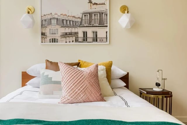 Bed with decorative pillows and artwork Bedroom at 20 Hawley Street in Binghamton Student Accommodation