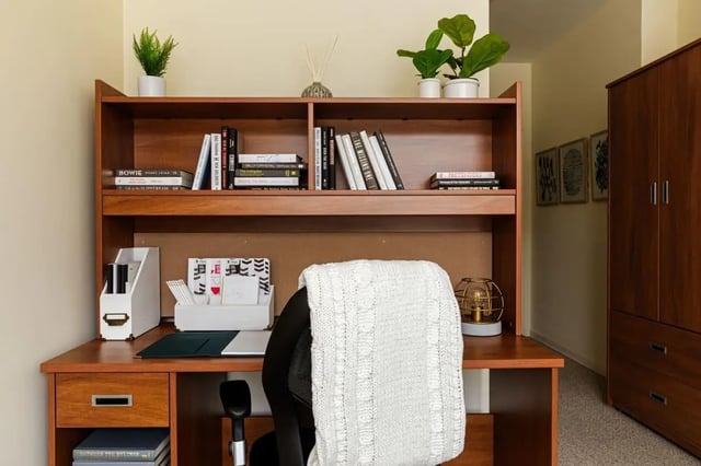 Desk with books and plants study area at 20 Hawley Street in Binghamton Student Accommodation