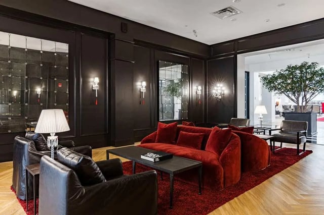 Red couch leather chairs table mirrors living room at 20 Hawley Street in Binghamton Student Accommodation