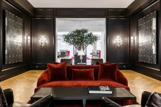 Red sofa large mirrors and tree living room at 20 Hawley Street in Binghamton Student Accommodation