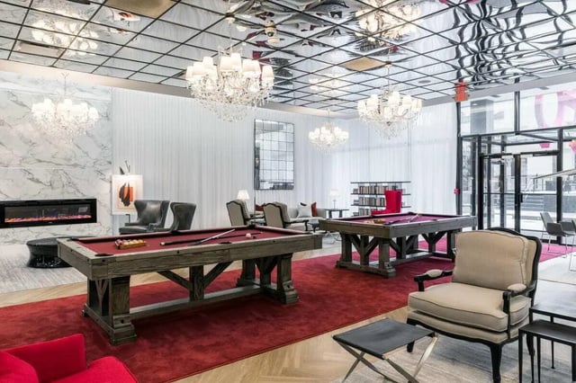 Pool tables chandeliers fireplace lounge area common room at 20 Hawley Street in Binghamton Student Accommodation