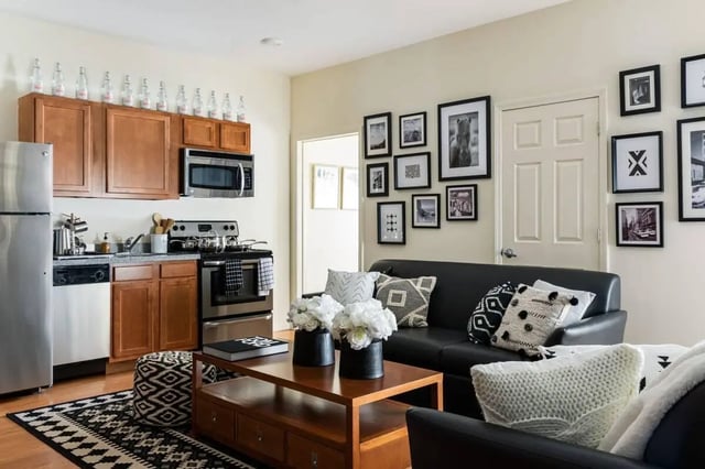Kitchen sofa coffee table and patterned rug living room at 20 Hawley Street in Binghamton Student Accommodation