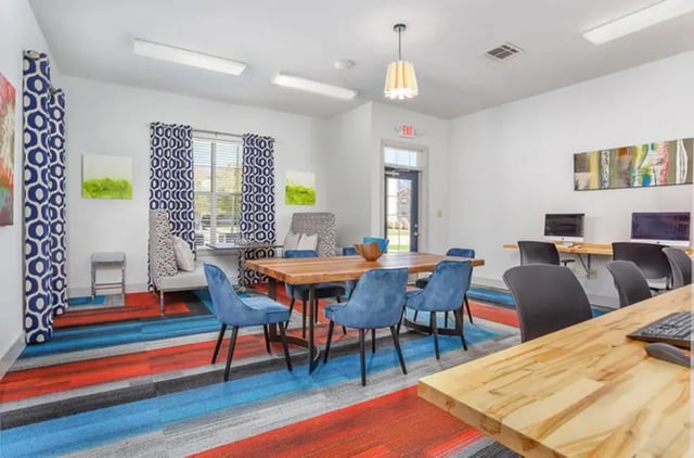 Blue chairs at wood table computers study area at University Crossing Apartments Ruston in Ruston Student Accommodation