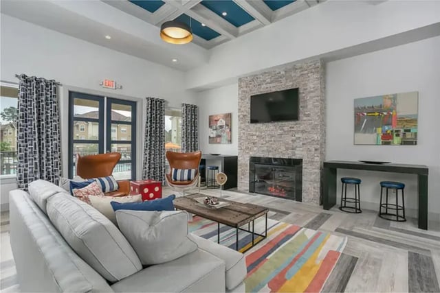 Sofa chairs coffee table fireplace living room at University Crossing Apartments Ruston in Ruston Student Accommodation