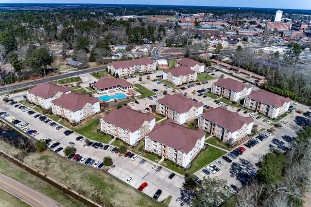 Apartment buildings with pool and parking exterior at University Crossing Apartments Ruston in Ruston Student Accommodation