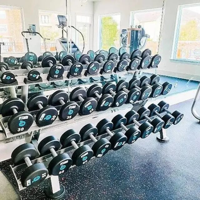 Dumbbells on racks in a gym Fitness area at University Crossing Apartments Ruston in Ruston Student Accommodation