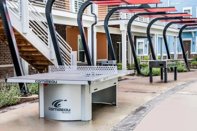 Ping pong table foosball table outdoor playing area at The Dillon Bloomington in Bloomington Student Accommodation