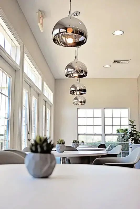 Pendant lights tables chairs plants common area at The Overlook at Nacogdoches in Nacogdoches Student Accommodation