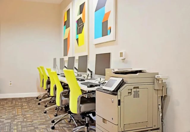 Computers chairs printer on desks study area at The Overlook at Nacogdoches in Nacogdoches Student Accommodation