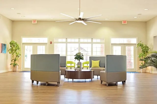 Modern seating area with plants and large fan Living room at The Overlook at Nacogdoches in Nacogdoches Student Accommodation