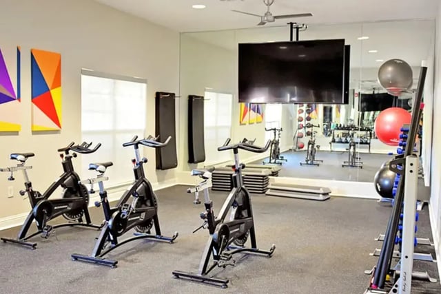 Spin bikes and weights in a gym. at The Overlook at Nacogdoches in Nacogdoches Student Accommodation