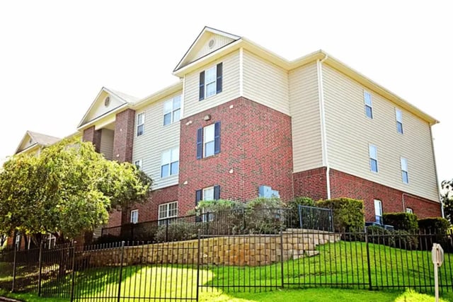 Apartment building with red brick and siding exterior exterior at The Overlook at Nacogdoches in Nacogdoches Student Accommodation