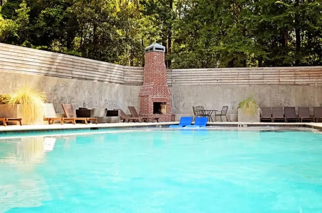 Pool with lounge chairs fireplace and table outdoor area at The Overlook at Nacogdoches in Nacogdoches Student Accommodation