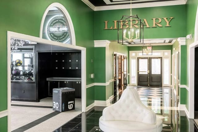 Gym equipment lockers and a white couch hallway at University Village at Greensboro in Greensboro Student Accommodation