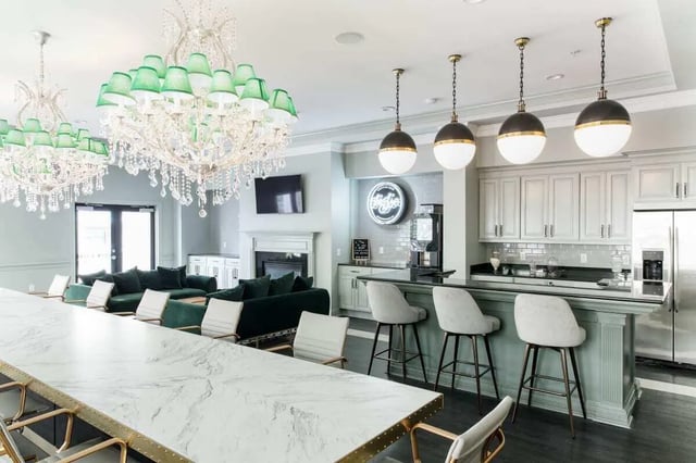 Marble counter bar white stools green couches kitchen living room at University Village at Greensboro in Greensboro Student Accommodation
