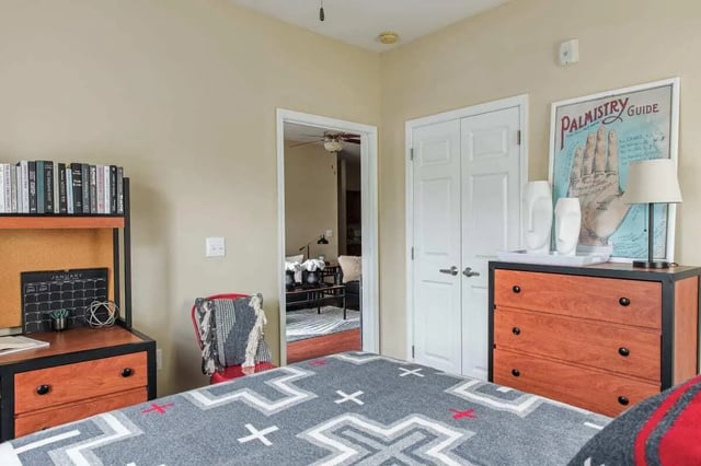 Bed desk chair dresser doors and living room bedroom at University Village at Greensboro in Greensboro Student Accommodation