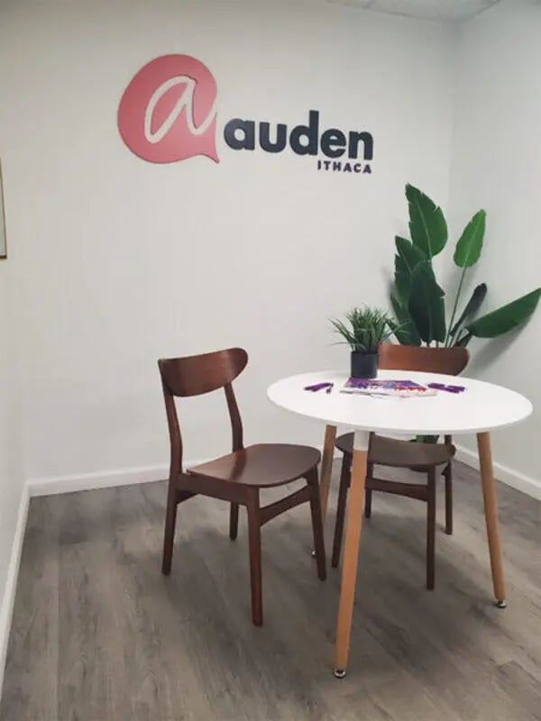 Auden Ithaca logo chairs and table common area at Auden Ithaca in Ithaca Student Accommodation